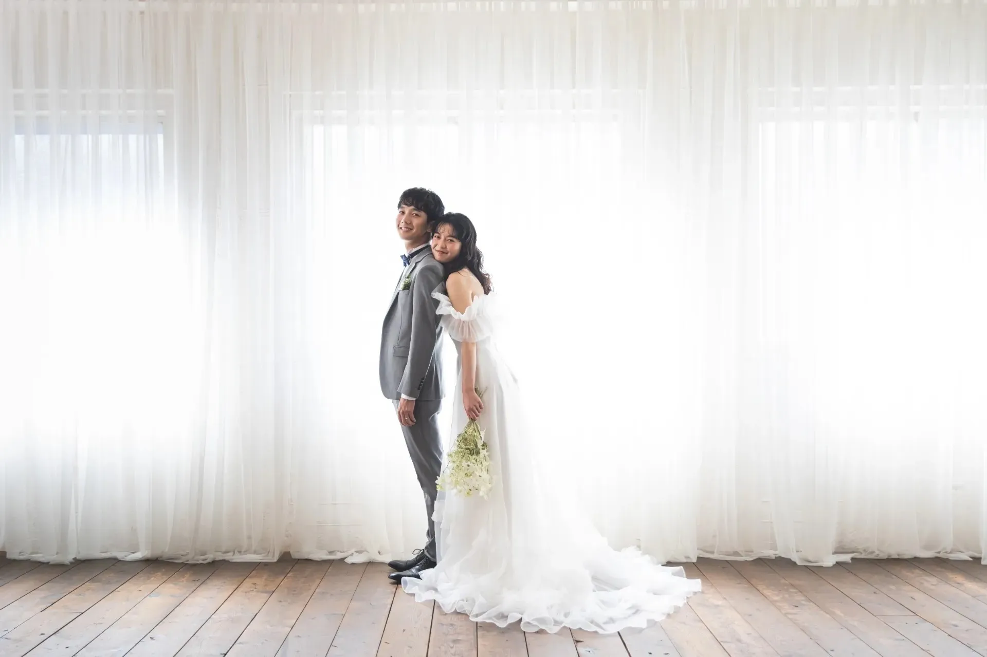 明るい部屋で寄り添う新郎新婦